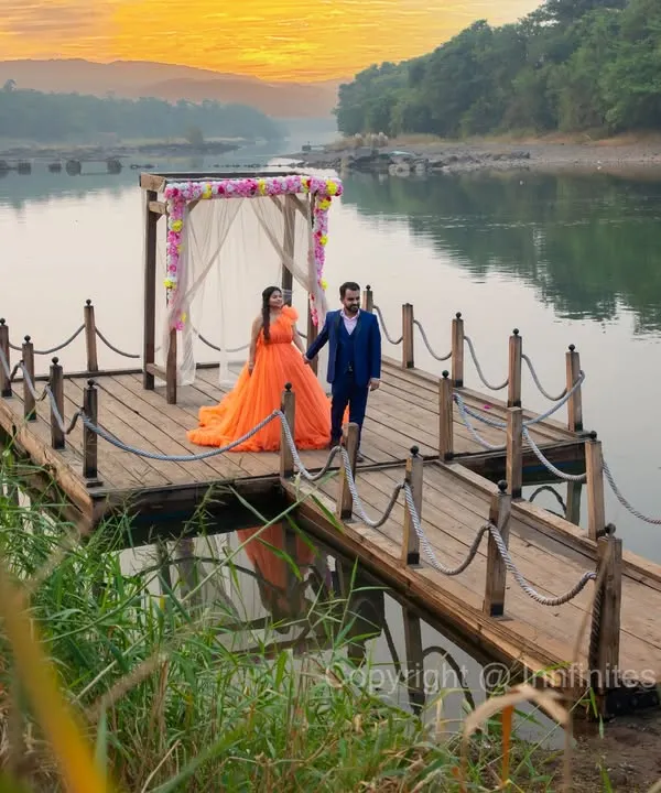 A breathtaking sunrise shoot on a wooden dock by the lake. The warm light and serene water create a truly magical and romantic pre-wedding setting.
