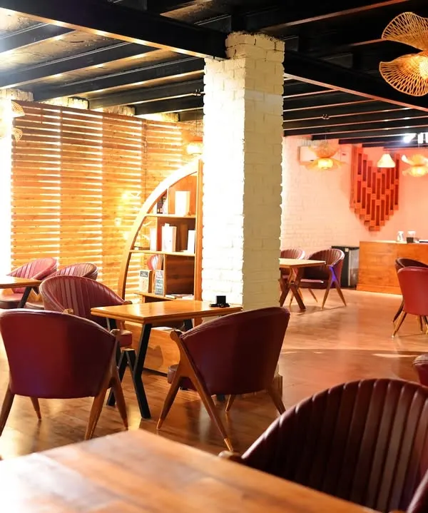 The indoor area of Sasa Cafe combines rustic wooden elements with modern, comfortable seating. It's a warm and inviting space, whether you're here for a coffee, a meal, or just to unwind with a good book.