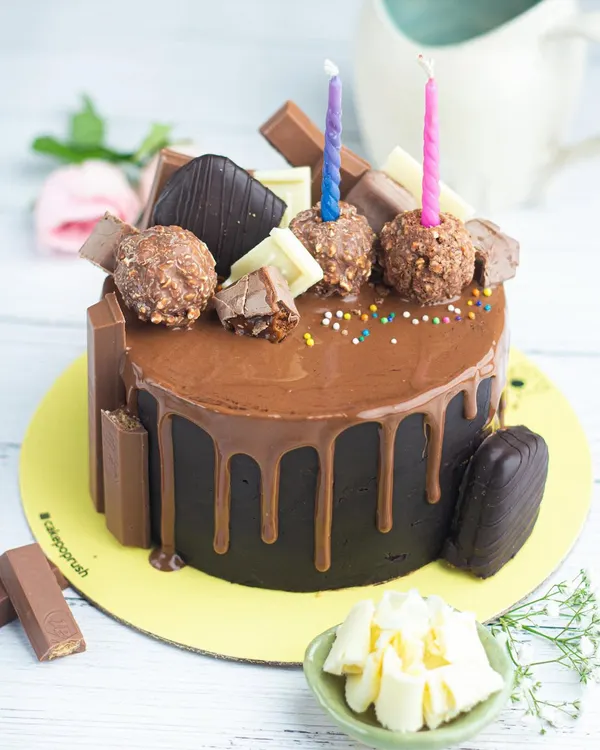 A chocolate lover's dream come true. This decadent chocolate drip cake is overloaded with Ferrero Rocher, KitKat, and other chocolate treats, making it one of our bestsellers.