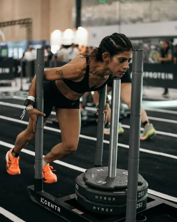 This is the moment where the work pays off. Pushing the sled in a HYROX race isn't just about strength; it's about pure grit. My coaching prepares you for this exact moment, building the power and mental toughness to drive through the pain and keep moving forward.