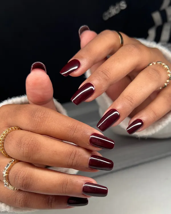 A timeless and sophisticated look. These long, coffin-shaped nails are painted in a deep, glossy burgundy for a look that is bold and elegant.