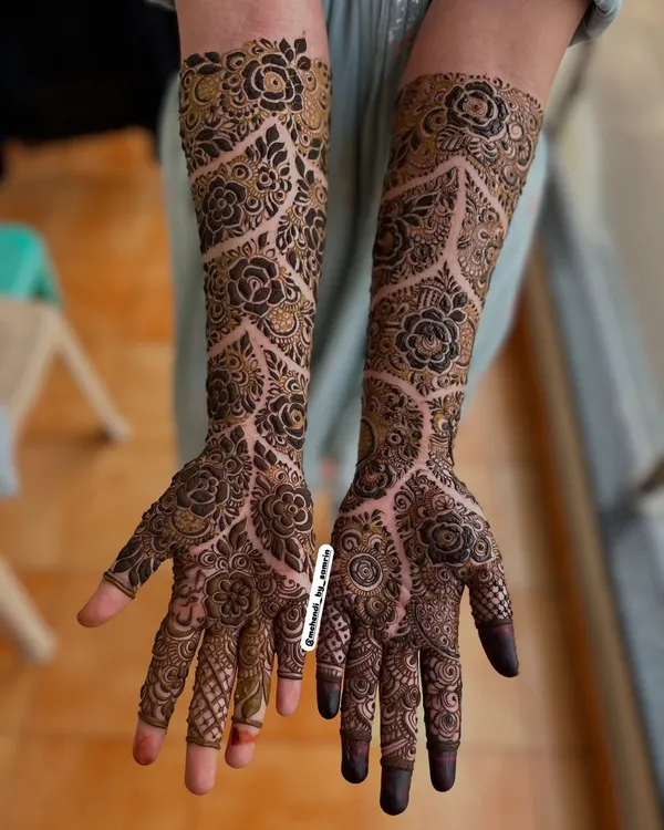 This is the kind of intricate, full-coverage floral design I absolutely love to create. The way the delicate vines and bold flowers flow from the fingers all the way up the arm is perfect for making a statement at any celebration.