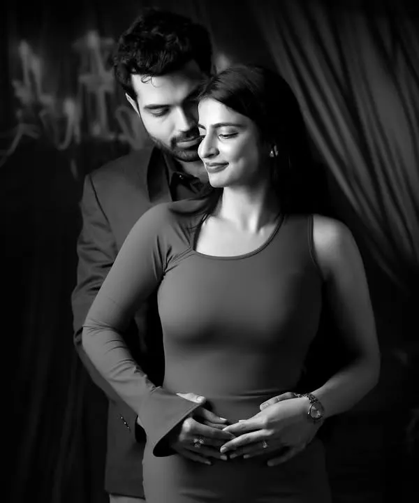 A timeless black and white couple portrait, showcasing our artistic approach to studio photography with dramatic lighting and a focus on emotion.