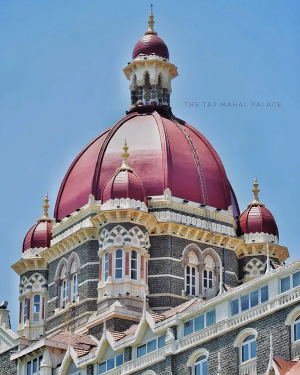 A detailed shot of the iconic red dome of The Taj Mahal Palace hotel, showcasing the intricate design of India's first luxury hotel.