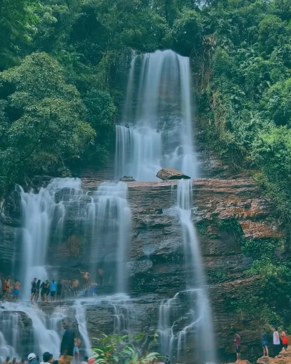 A majestic, multi-tiered waterfall in Chikmagalur, with our group visible at the base. This shot captures the scale and power of the waterfalls we visit.