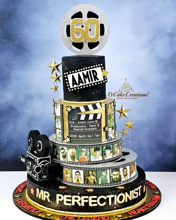 This multi-tiered masterpiece was a dream come true to create for Aamir Khan's 60th birthday. It features edible film reels showcasing his iconic roles, a vintage camera, and a sparkling film reel topper, celebrating the journey of a legend.