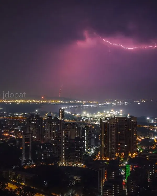 A powerful lightning bolt spreads across the night sky over the Mumbai sea and the Trans Harbour Link, captured with a drone.