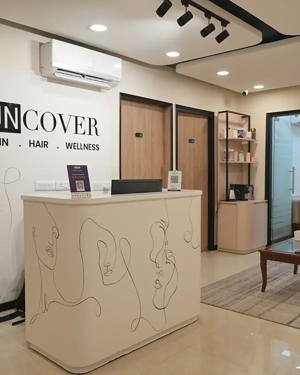 The reception desk at our Lajpat Nagar clinic, featuring our signature line-art aesthetic.