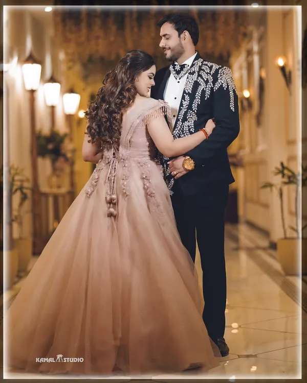 A fairytale moment from an engagement night. The beautiful gown, the elegant ballroom, and the loving gaze all come together to create a picture of pure romance.