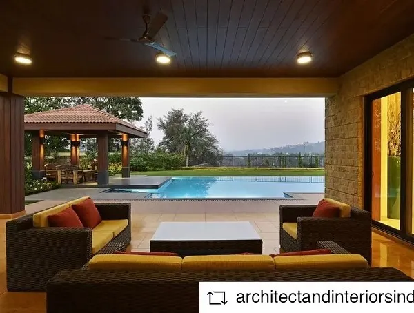 This is an outdoor seating area of a weekend home we designed in the Khandala valley. The covered patio seamlessly connects the indoor living space with the pool and lawn, offering picturesque views and a perfect space for relaxation.