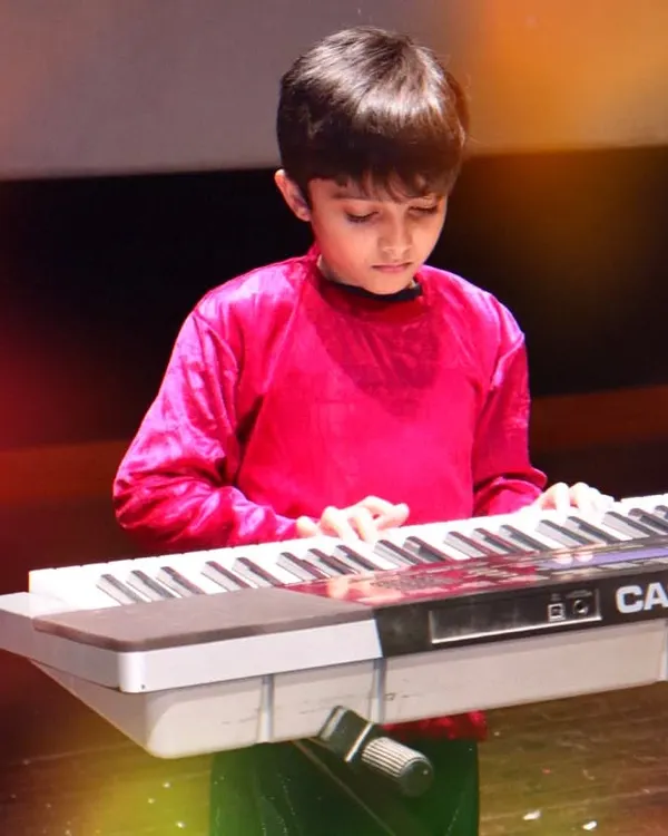 A young student completely focused during his keyboard performance at our annual 'Pehal' music festival. I believe in giving students the platform to shine and build their confidence on stage.