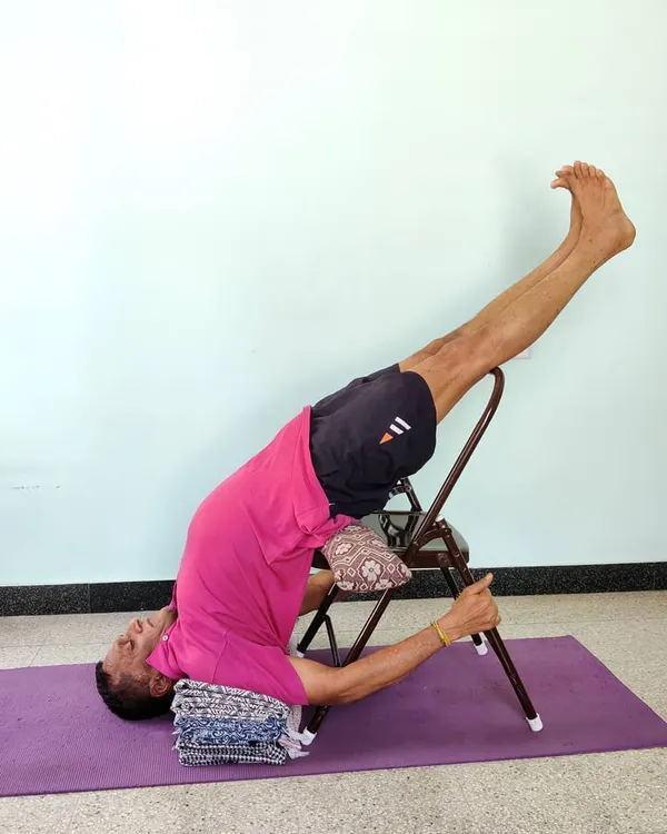 Chair Sarvangasana, or supported shoulder stand, is a cornerstone of the Iyengar method. The chair provides support to the back, allowing for a longer, more beneficial hold.
