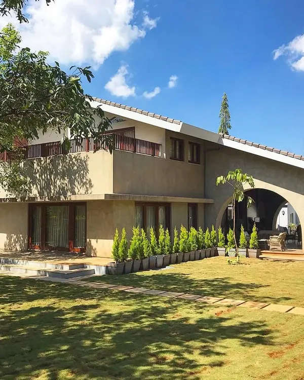 A stunning Khandala holiday home we had the pleasure of landscaping for a renowned film director. The design focused on creating a large, open lawn for relaxation and events, framed by carefully selected trees and shrubs that complement the home's earthy architecture.