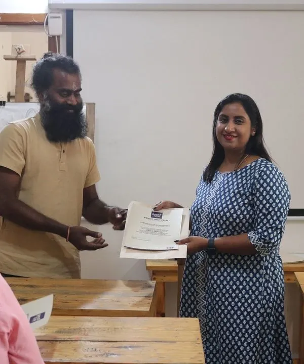 A proud moment as a student receives her course completion certificate. Our certification is not just for attendance; it acknowledges the dedication and practice required to complete all assignments.