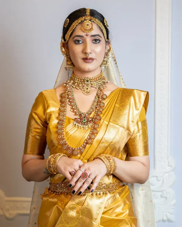 A classic South Indian bridal look featuring a stunning gold Kanjeevaram saree. I created a warm, golden makeup look with defined eyes and a traditional matha patti, ensuring the bride looks regal and radiant.