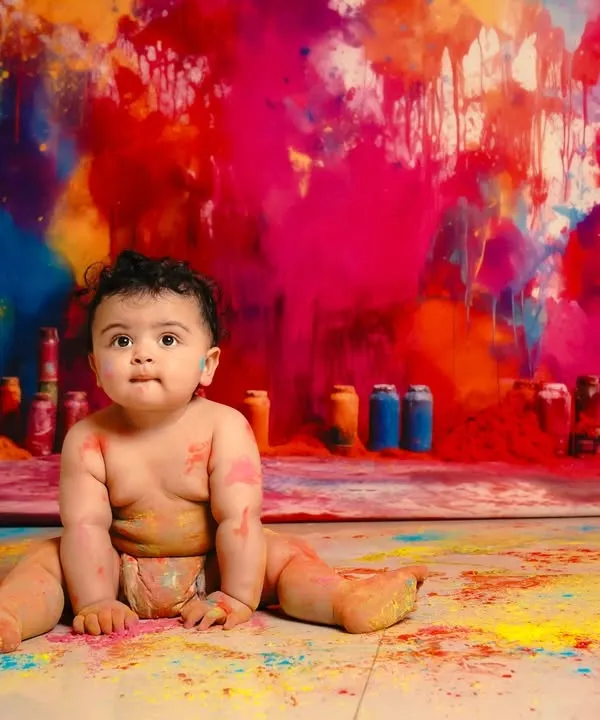 This is what pure, uninhibited joy looks like. We love creating unique and colorful setups like this paint smash session, allowing your baby's personality to shine through in the most vibrant way possible.