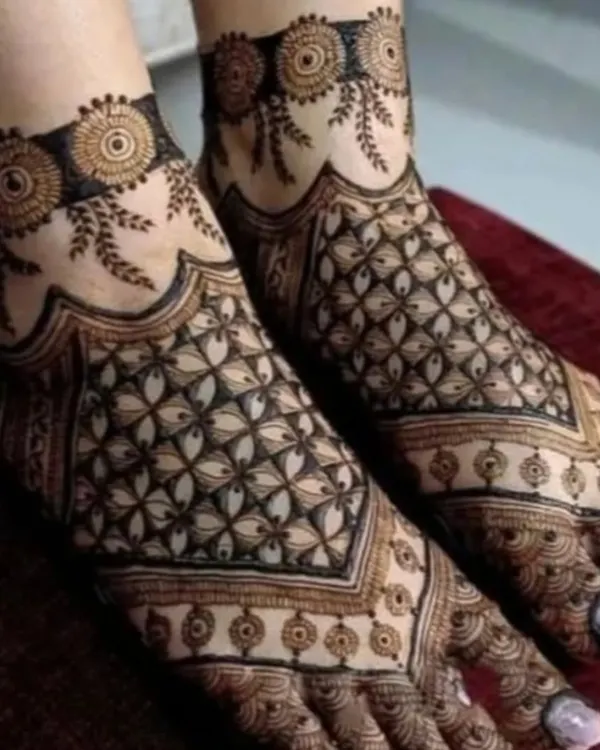 A modern and chic foot mehandi design featuring a geometric jaali (net) pattern that covers the entire foot.