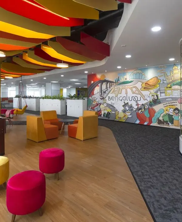 This dynamic breakout area for Scientific Games in Bengaluru is designed to energize and inspire. We integrated a foosball table, varied seating options, and a large, custom mural depicting local culture to create a space that fosters informal collaboration and relaxation.
