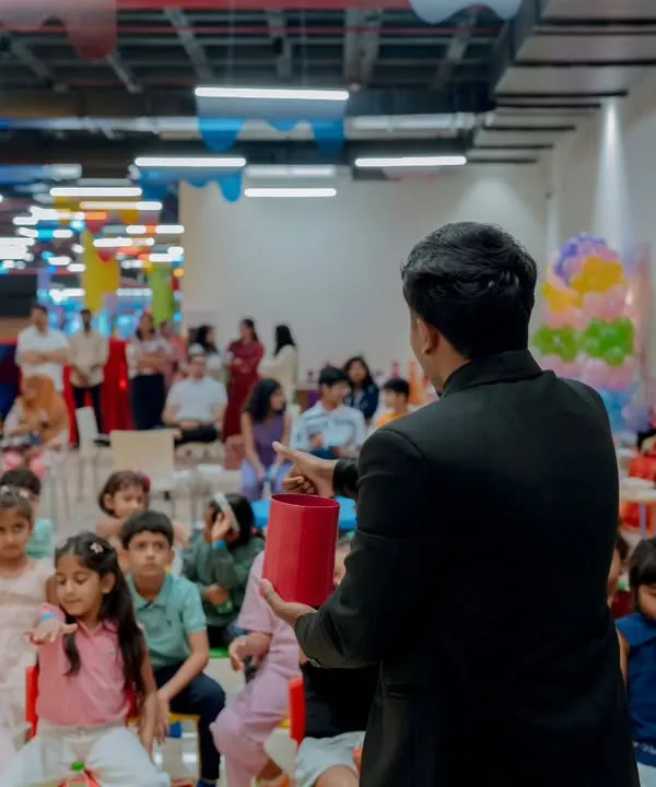 Kicking off a birthday magic show for an excited group of kids. I love seeing them all gathered and ready for the surprises to begin. This kind of setup is great for party halls and dedicated event spaces.