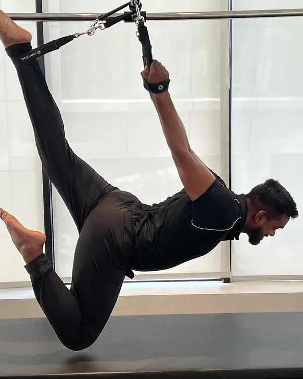 This pose on the Cadillac requires immense core strength and flexibility. It's an example of the advanced bodyweight control we work towards.