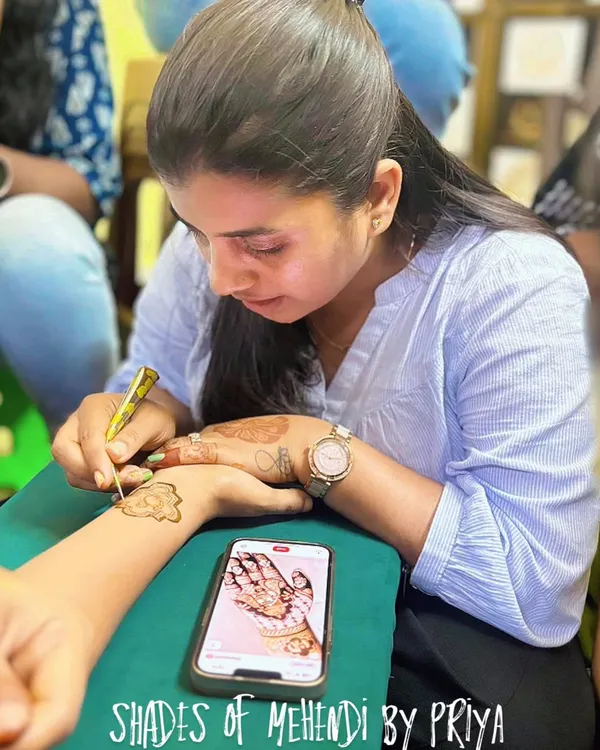 This is me in my element, focused on creating a design for a client. I often use a reference photo on my phone to ensure the design is exactly what they want.