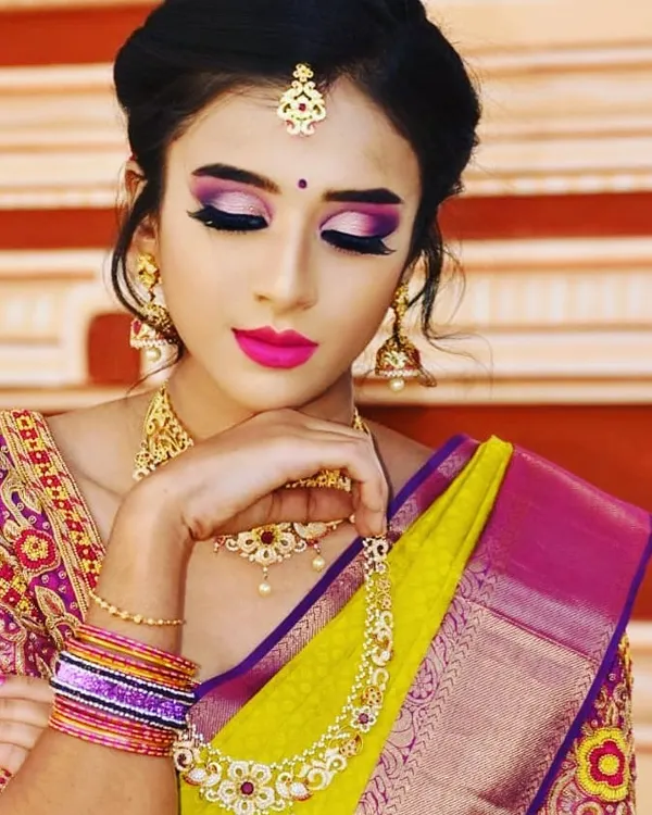 For this traditional photoshoot, I created a vibrant and dramatic eye makeup look using a blend of purples and pinks to complement the rich silk saree. The look is finished with a bold pink lip and glowing skin, perfect for making a statement in your photos.