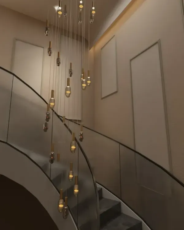 For this Gurgaon residence, I designed a breathtaking foyer around a double-height cascading chandelier. This statement piece immediately establishes a sense of luxury and grandeur, drawing the eye upward and filling the voluminous space.