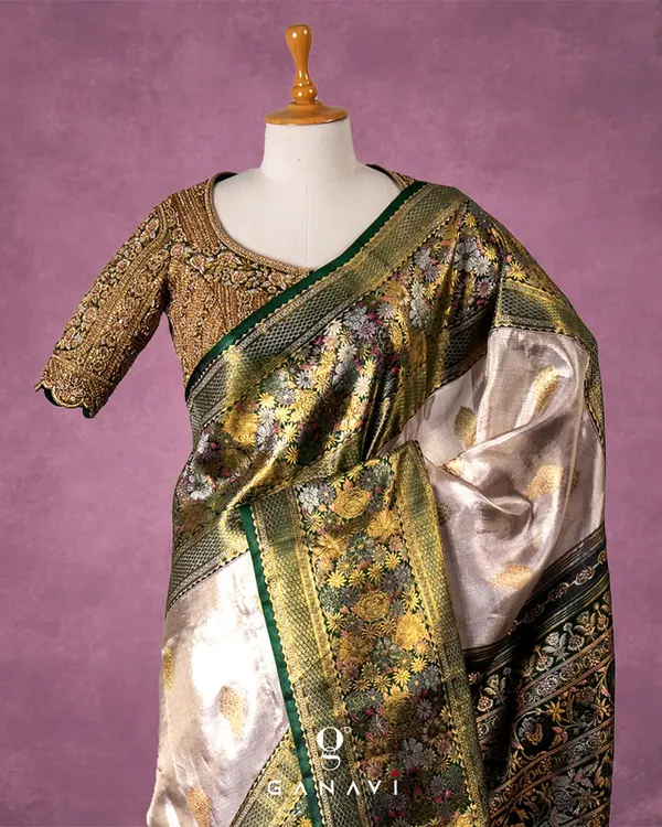 A masterpiece of hand-embroidery, this blouse is fully covered in dense, intricate gold threadwork. The design features traditional floral and paisley motifs, creating a rich, tapestry-like effect that is the epitome of bridal luxury.