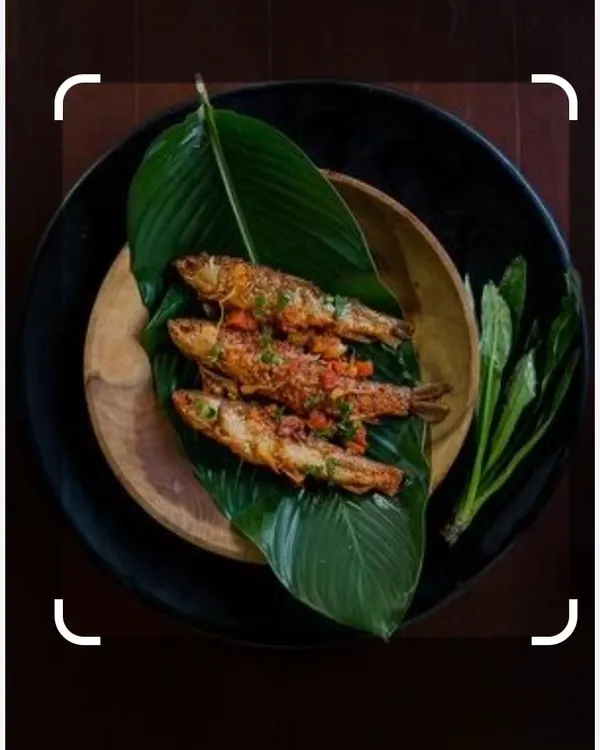 This is fish prepared in the Naga style, served on a banana leaf. The presentation is as traditional as the recipe, which uses local herbs and spices.
