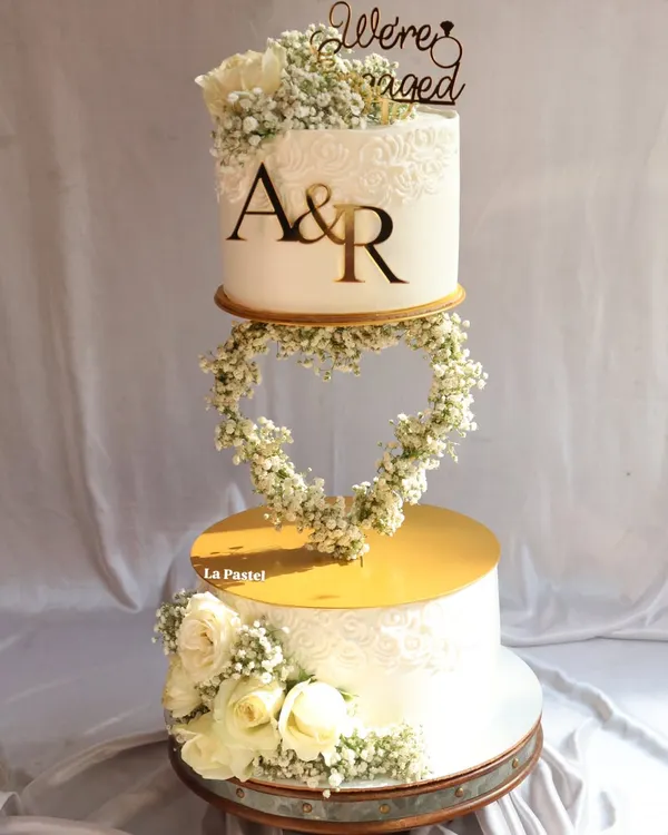 This is what cake dreams are made of. I created this floating tier wedding cake with a delicate, heart-shaped garland of baby's breath, making it a true centerpiece for a romantic engagement or wedding ceremony.