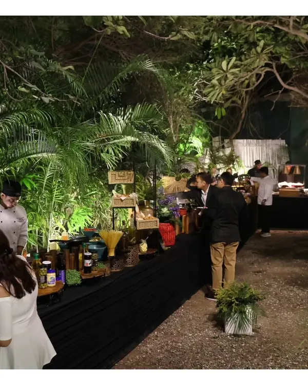 An overview of our buffet setup at the Garden of Five Senses. This image shows our team in the background, diligently working to ensure the food is perfectly presented and replenished throughout the event.