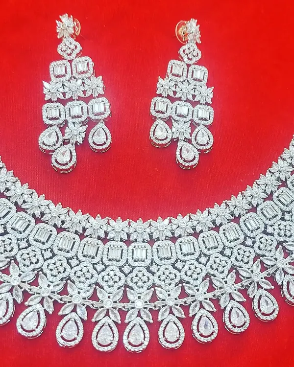 This rhodium-plated American Diamond necklace set is a showstopper. The intricate design and brilliant sparkle make it the perfect accessory for a glamorous sangeet or reception night.