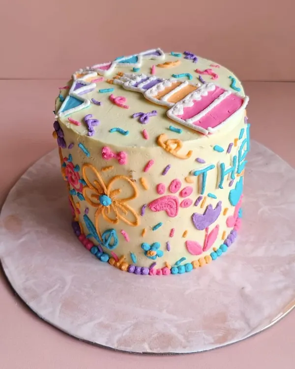 A close-up of the detailed piping on Theo's cake. We hand-pipe every flower, paw print, and letter to make your pet's cake truly special.