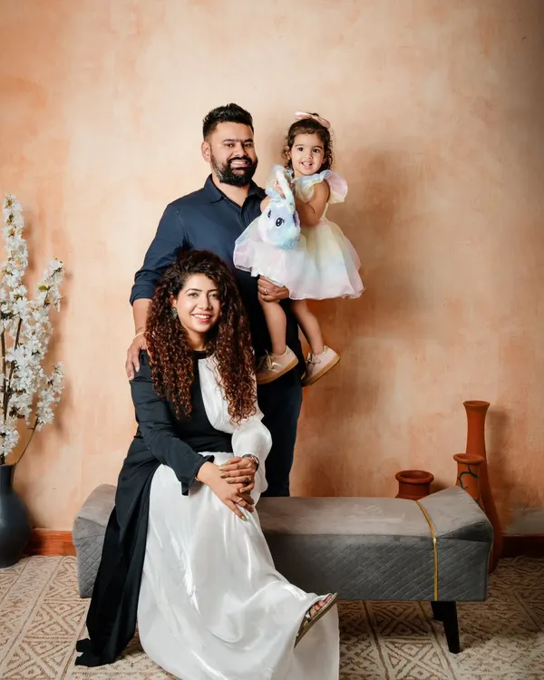 A beautiful family portrait against an earthy, textured backdrop. I guide families into comfortable poses that feel natural, allowing their personalities to shine through.