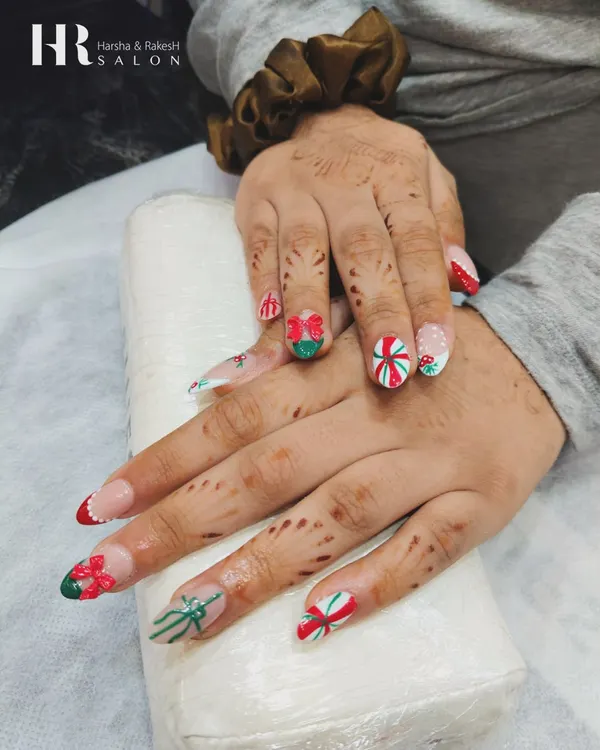 Getting into the festive spirit with this Christmas-themed set. We created fun 3D gift bows in red and green and hand-painted candy cane stripes for a cheerful holiday manicure.