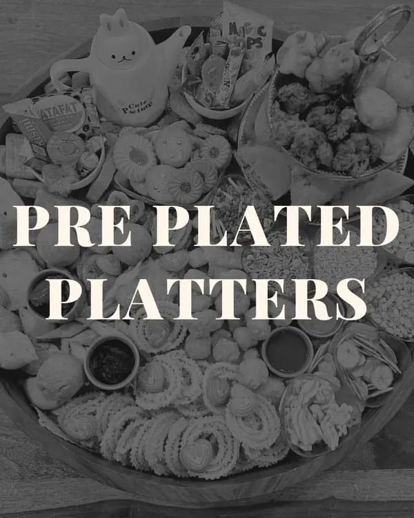 An introduction to our pre-plated platters. This black and white image showcases a chai board, highlighting the variety and abundance we pack into every single platter we create.