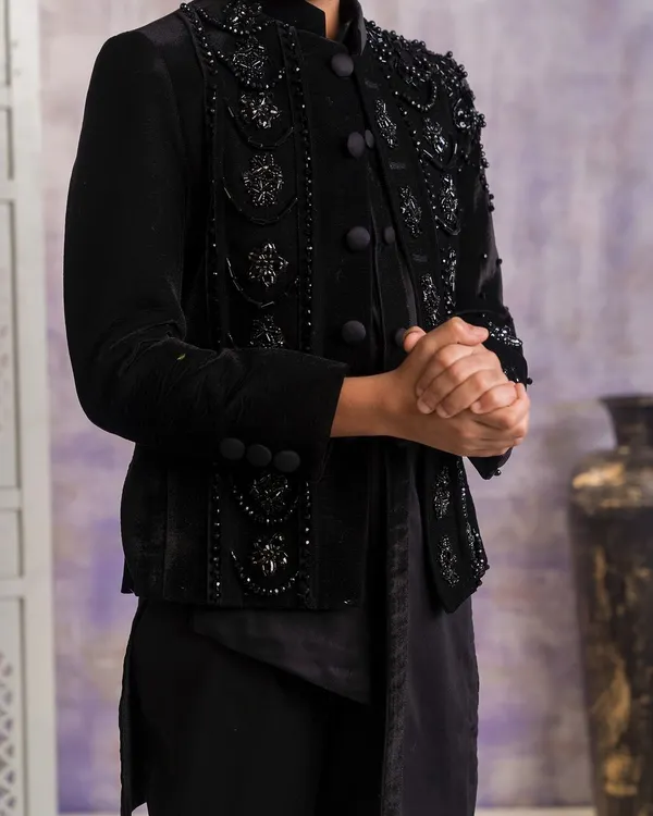 A detailed close up of the black velvet Indo-western jacket. You can see the intricate black on black beadwork and embroidery that I use to create a rich, textured look.