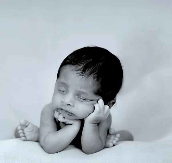 The peaceful sleep of a newborn. We capture these delicate moments in classic black and white to create timeless art for your home.