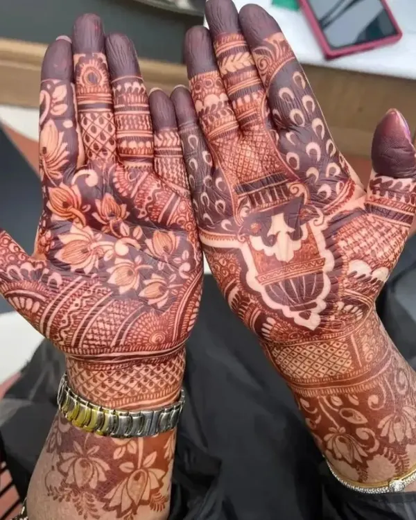 A close-up of a full-hand bridal style mehndi, showing the deep color achieved with my natural henna. The design combines floral patterns with traditional Indian motifs.
