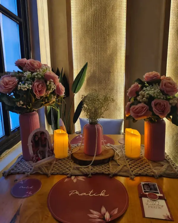 An intimate and personalized table setup for two. We used custom placemats, floral arrangements, and candles to create a romantic dinner setting.