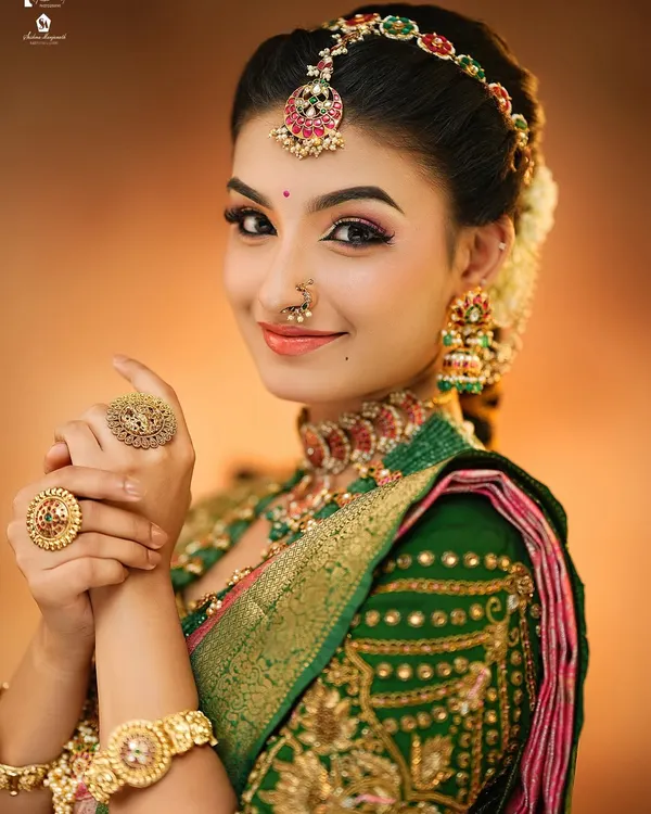 A close-up of a classic South Indian bridal look. You will learn how to create this radiant skin finish and perfectly defined eye makeup that complements traditional gold jewelry.
