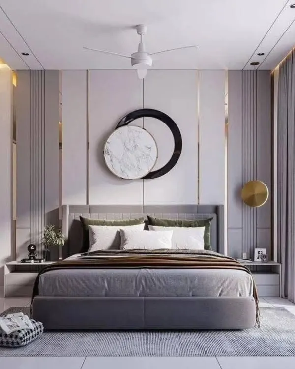 This 3D render of a master bedroom showcases a luxurious and modern aesthetic. The feature wall behind the bed combines vertical paneling with metallic accents and a central art piece. The neutral color palette and soft lighting create a sophisticated and calming environment.