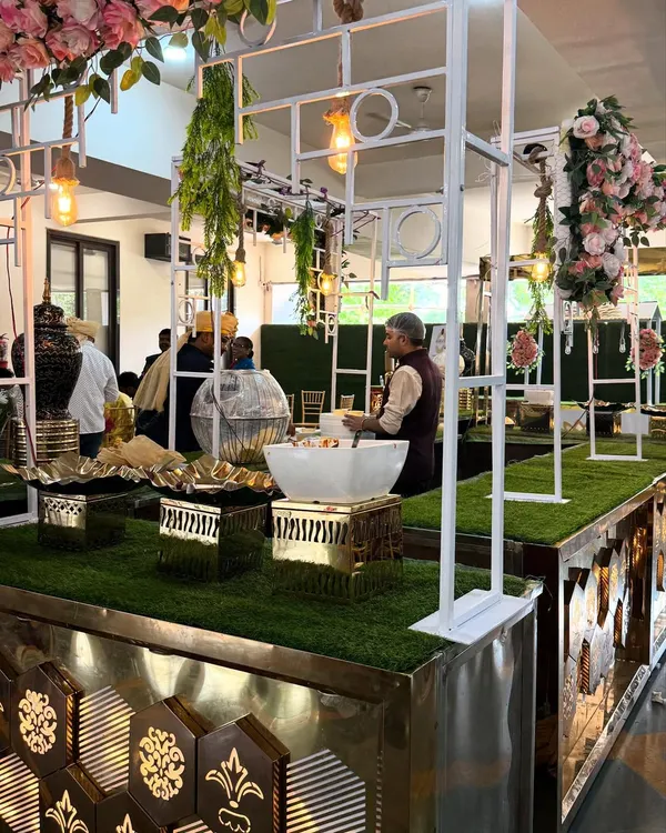 A full view of a grand buffet presentation for a daytime wedding. The combination of greenery, florals, and metallic details creates a fresh and inviting atmosphere.