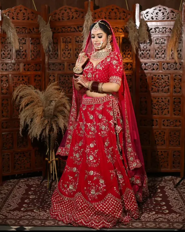 This classic red bridal lehenga is a dream come true for any bride. I've designed this piece with rich velvet and detailed embroidery to make sure you feel like royalty on your special day. Since I manufacture my own collection, I can offer this stunning look at a price that makes sense.