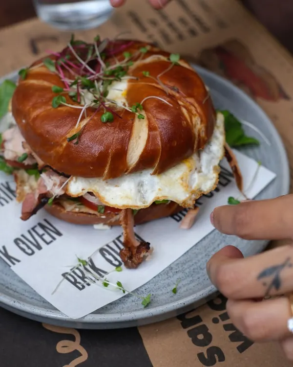 Our pretzel bagel sandwich, loaded with a fried egg and savory ham. The unique flavor of the lye-dipped pretzel bagel makes this a breakfast you won't forget.