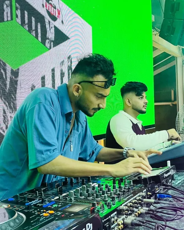 In the booth with my partner. We work together to manage the sound and visuals, ensuring a seamless show from start to finish.