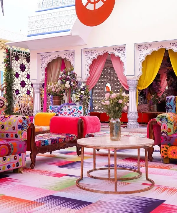 We transformed the courtyard at The Leela Jaipur into a kaleidoscope of color for a vibrant Haldi. The space features eclectic, brightly upholstered furniture and a multi-hued floor, creating a festive and energetic atmosphere for the celebration.
