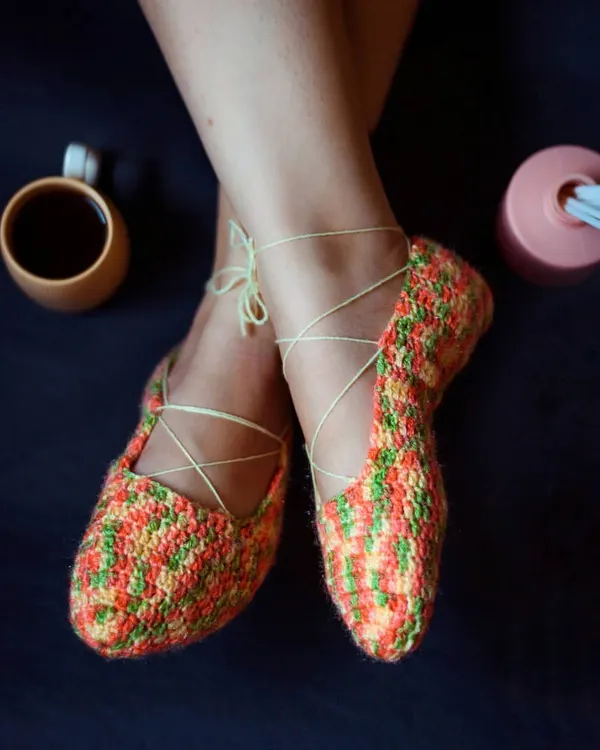 Our ballet-style crochet booties are perfect for feeling cozy and elegant at home. The multi-colored yarn creates a beautiful pattern, and the ties can be laced up your ankle.
