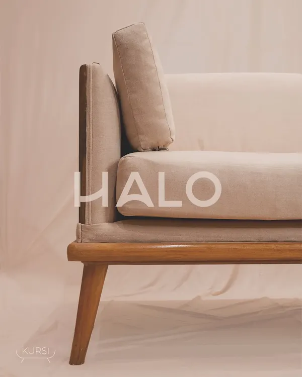 The 'Halo' sofa, crafted from the rich, warm tones of teak wood and softened by the luxurious embrace of fabric cushions. This is where comfort meets artistry.