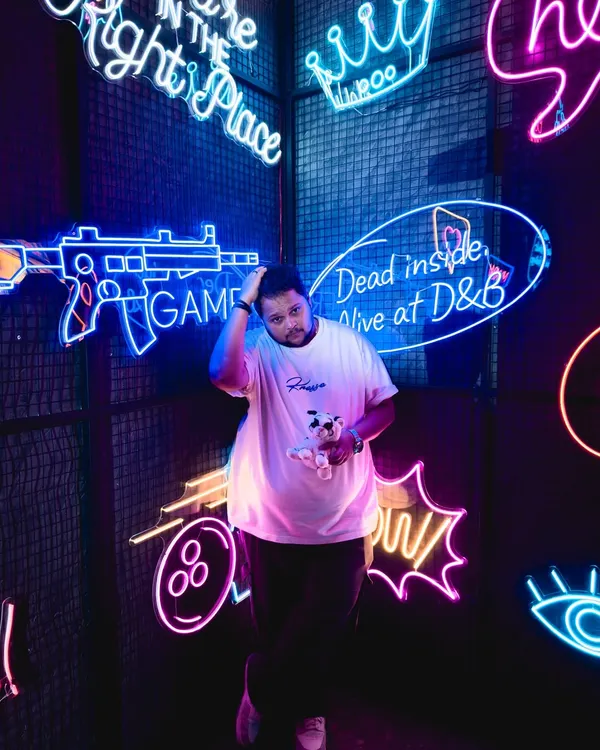 Me in my element, surrounded by neon lights. The vibrant colors and energy of places like this inspire the music I create.